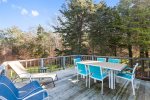 Large deck with dining table and lounging furniture